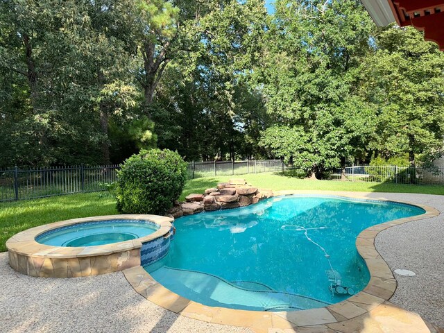 view of pool featuring a yard and an in ground hot tub