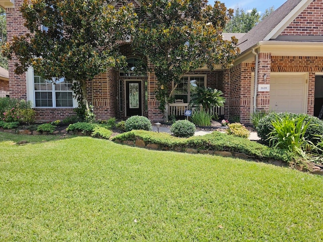 view of front of home with a garage and a front yard