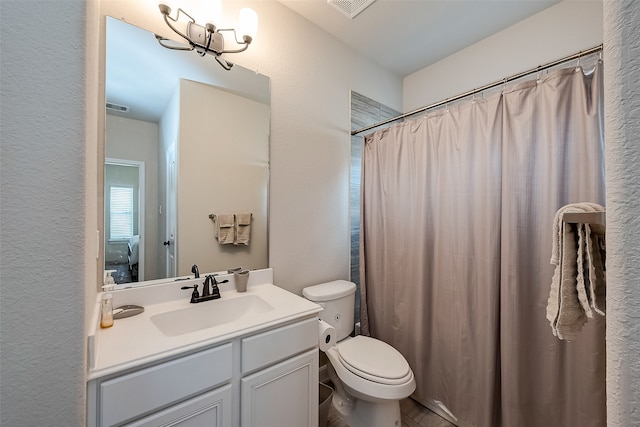 bathroom with vanity, toilet, and curtained shower