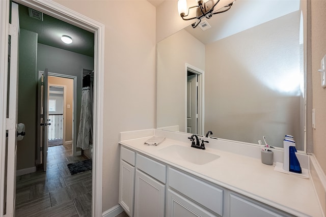 bathroom with vanity and parquet flooring