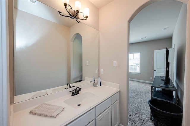 bathroom featuring vanity and a chandelier