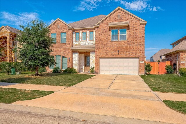 view of front of house featuring a front yard and a garage