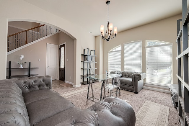 living room with a chandelier and carpet flooring