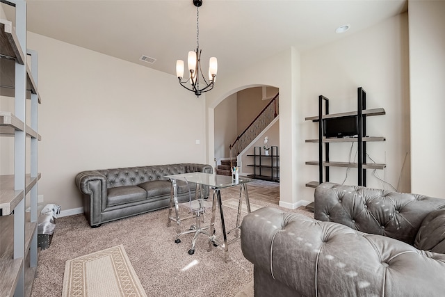 carpeted living room featuring a chandelier