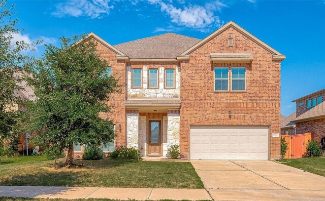 view of front of home featuring a front yard and a garage