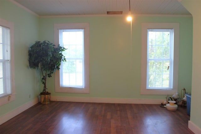 unfurnished room with dark hardwood / wood-style flooring and crown molding