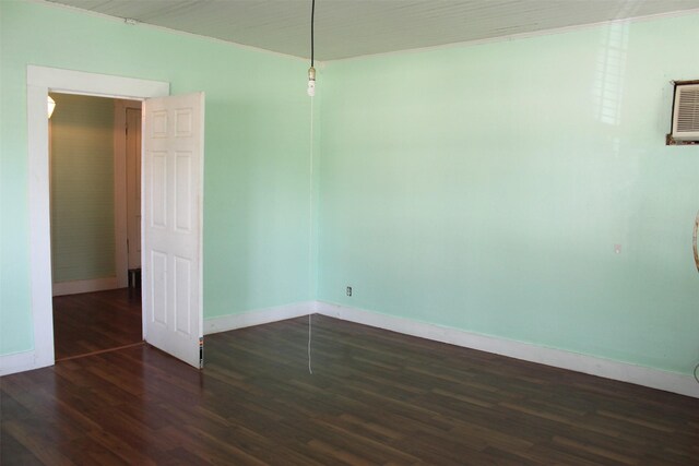 unfurnished room with dark hardwood / wood-style flooring