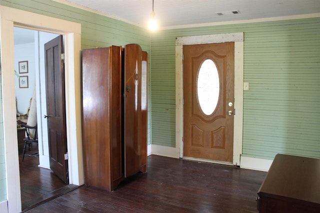 foyer entrance featuring dark hardwood / wood-style flooring and wood walls