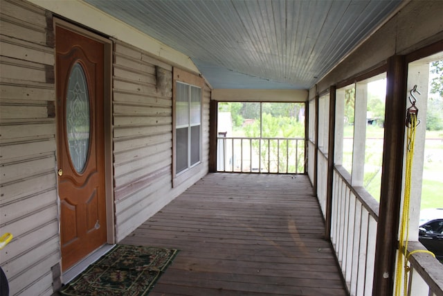 unfurnished sunroom featuring a healthy amount of sunlight and vaulted ceiling