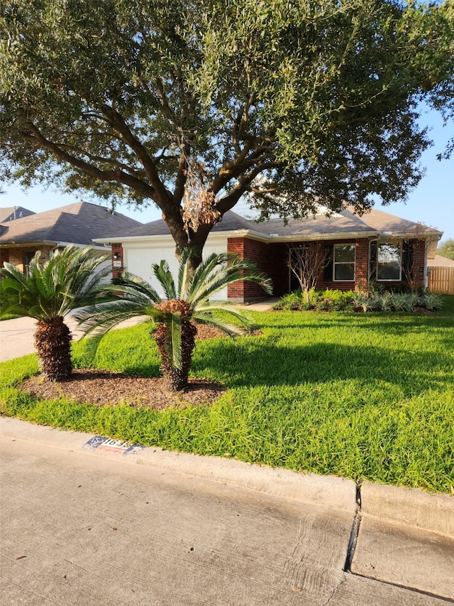 single story home with a garage and a front yard