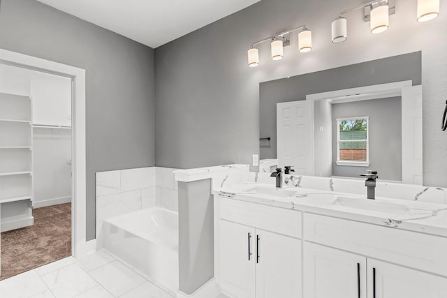 bathroom featuring vanity and a tub