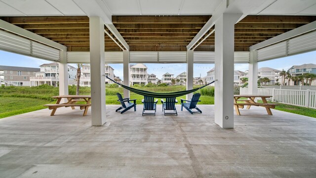 view of patio featuring fence and a residential view