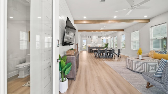 living area featuring a ceiling fan, baseboards, beam ceiling, light wood-style flooring, and recessed lighting