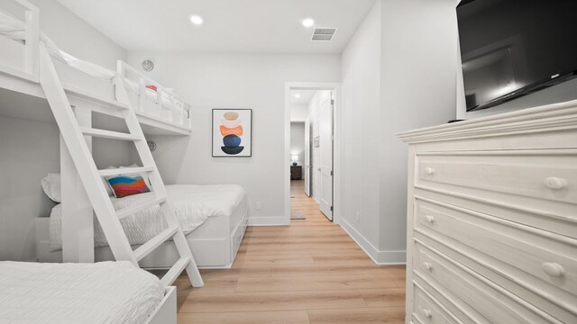 bedroom with light wood-style flooring, recessed lighting, visible vents, and baseboards