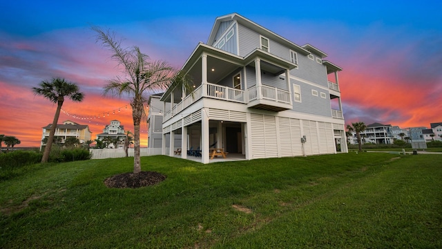 back of property with a yard and a patio area