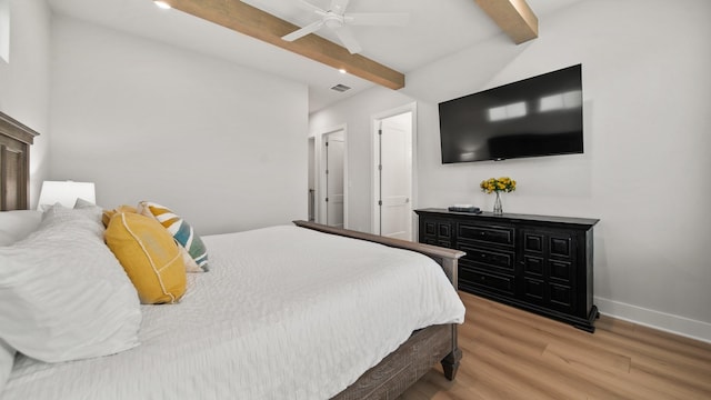 bedroom featuring light wood-type flooring, visible vents, beam ceiling, baseboards, and ceiling fan