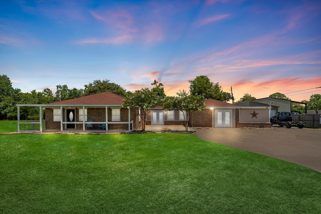 ranch-style home with a lawn