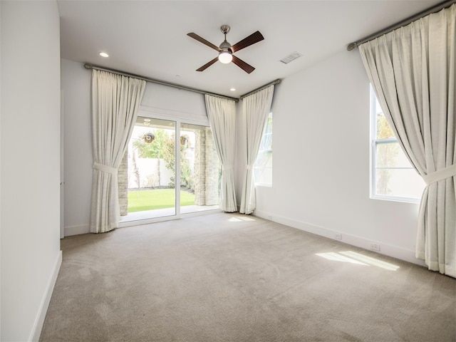 carpeted empty room featuring ceiling fan