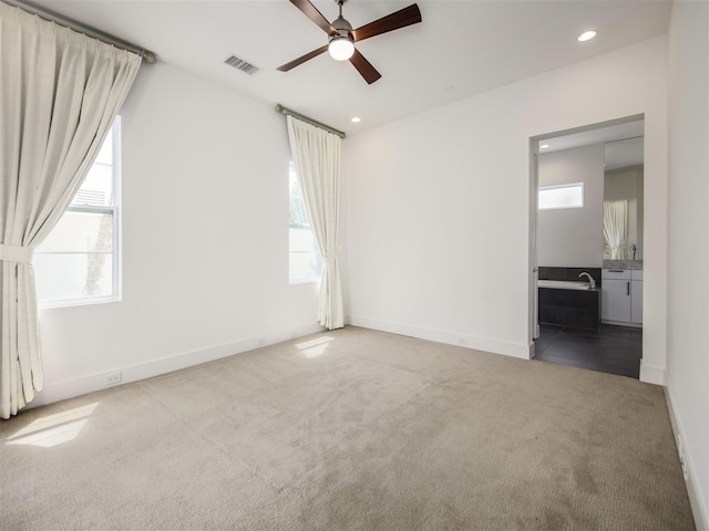 empty room featuring carpet floors and ceiling fan