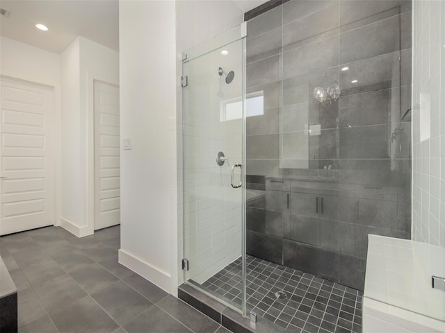 bathroom with tile patterned floors and a shower with shower door