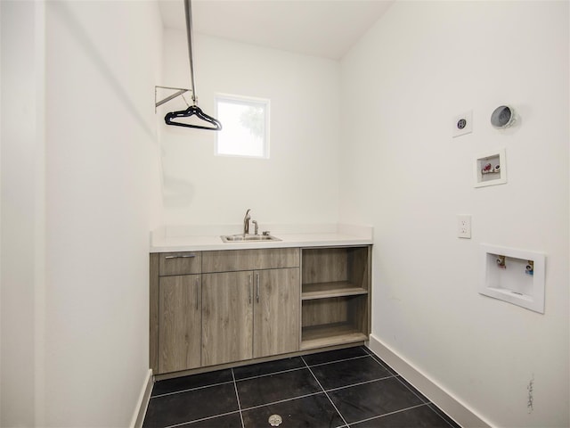 laundry area with hookup for a washing machine, electric dryer hookup, sink, and dark tile patterned flooring