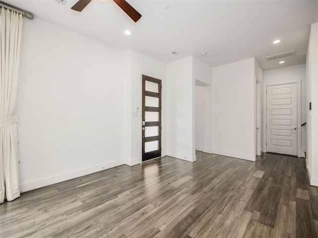 spare room with ceiling fan and dark hardwood / wood-style flooring