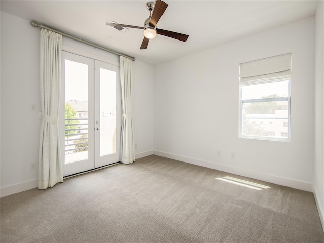 unfurnished room with french doors, light colored carpet, and ceiling fan