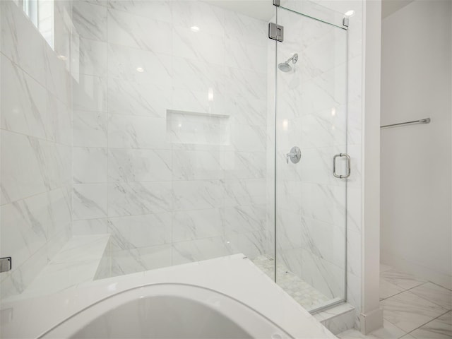 bathroom featuring separate shower and tub