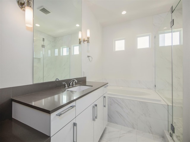 bathroom featuring vanity and shower with separate bathtub