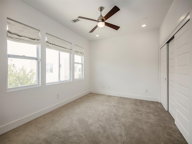 unfurnished bedroom featuring ceiling fan, carpet floors, and a closet