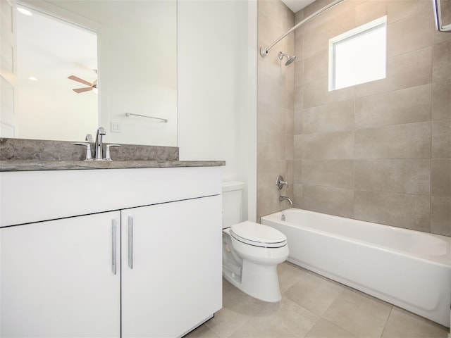 full bathroom featuring toilet, tiled shower / bath, vanity, ceiling fan, and tile patterned flooring