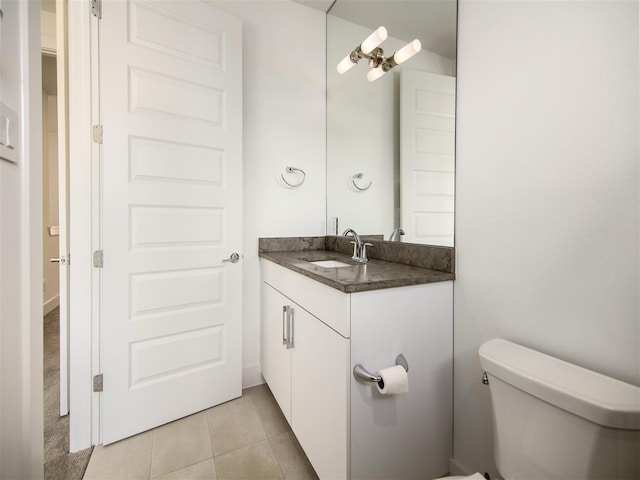 bathroom with vanity, tile patterned floors, and toilet