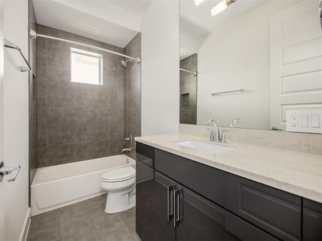 full bathroom with tiled shower / bath, vanity, toilet, and tile patterned floors