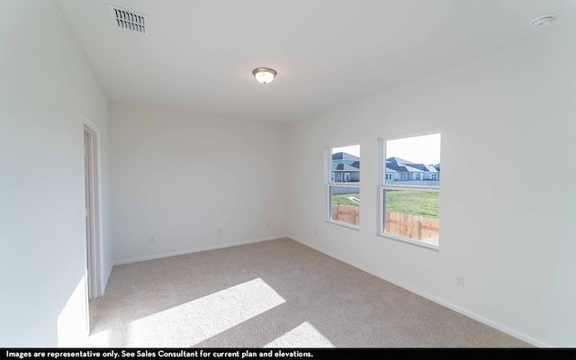 spare room featuring carpet