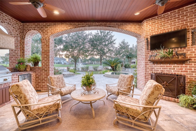 view of patio / terrace with exterior kitchen, a grill, and ceiling fan