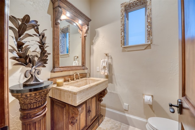 bathroom with toilet and vanity