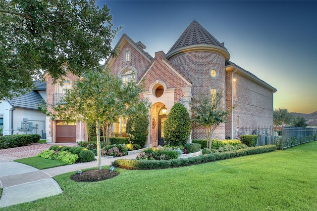 view of front of home with a yard and a garage