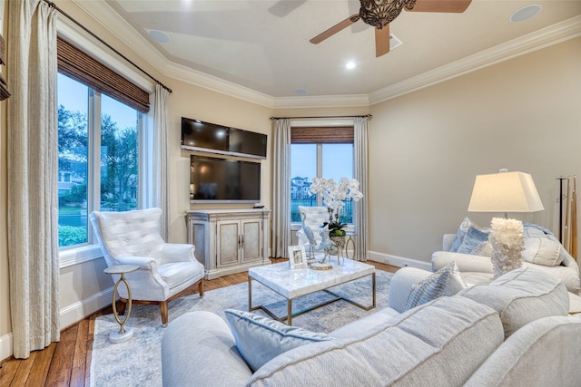 living room with ceiling fan, crown molding, and hardwood / wood-style flooring