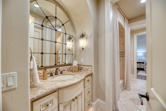 bathroom featuring vanity and shower / bath combo with shower curtain