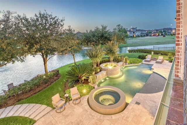 exterior space with a water view and a patio