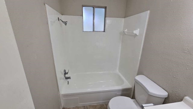 bathroom featuring  shower combination and toilet