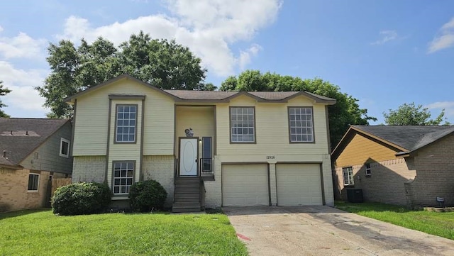 view of front of home featuring a garage, central AC, and a front yard