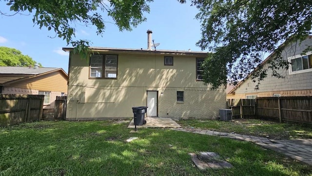 rear view of house with a patio, a yard, and cooling unit