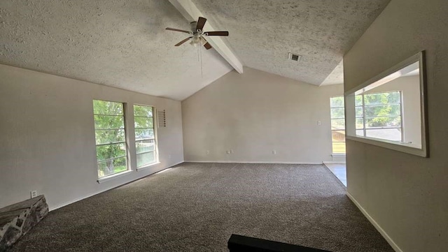 carpeted spare room with a textured ceiling, ceiling fan, and vaulted ceiling with beams