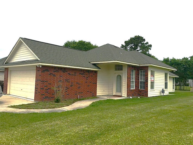 single story home featuring a garage and a front lawn