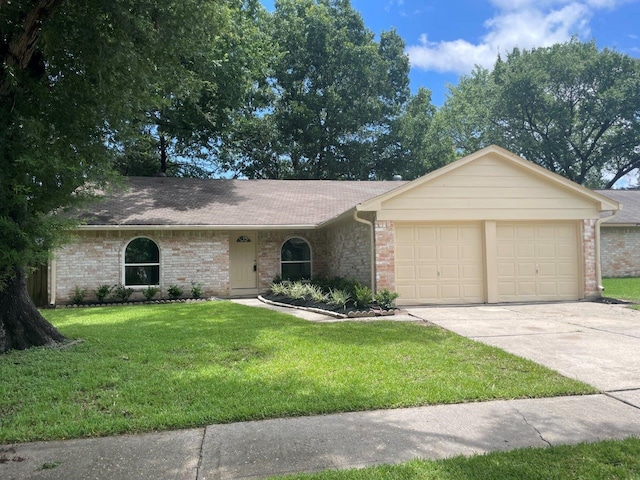 ranch-style house featuring brick siding, roof with shingles, an attached garage, a front yard, and driveway