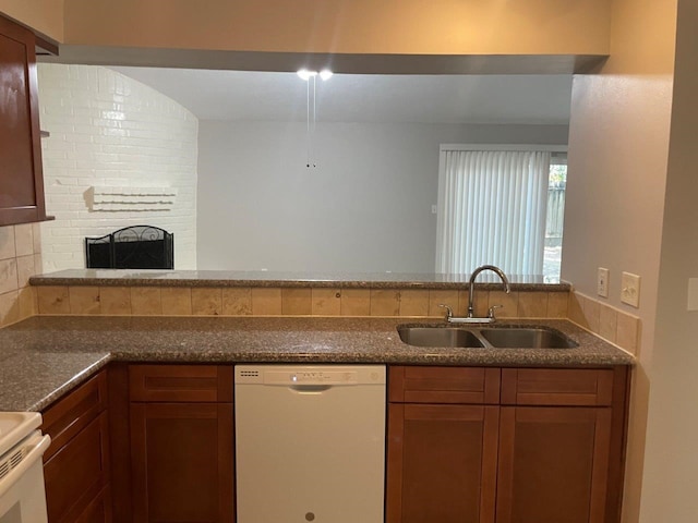 kitchen with tasteful backsplash, brown cabinetry, dishwasher, a fireplace, and a sink