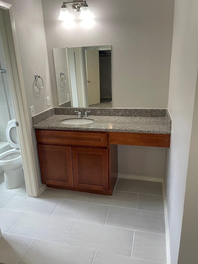 bathroom with vanity, toilet, and tile patterned floors