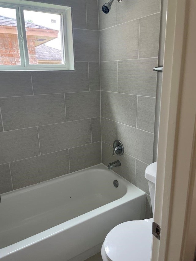 bathroom featuring toilet and washtub / shower combination