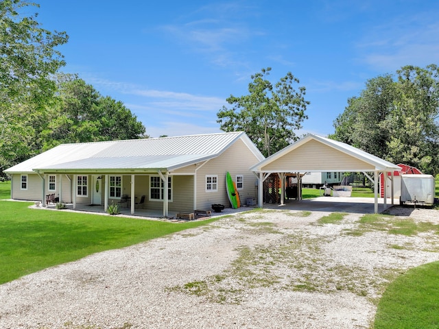 ranch-style home with covered porch and a front yard